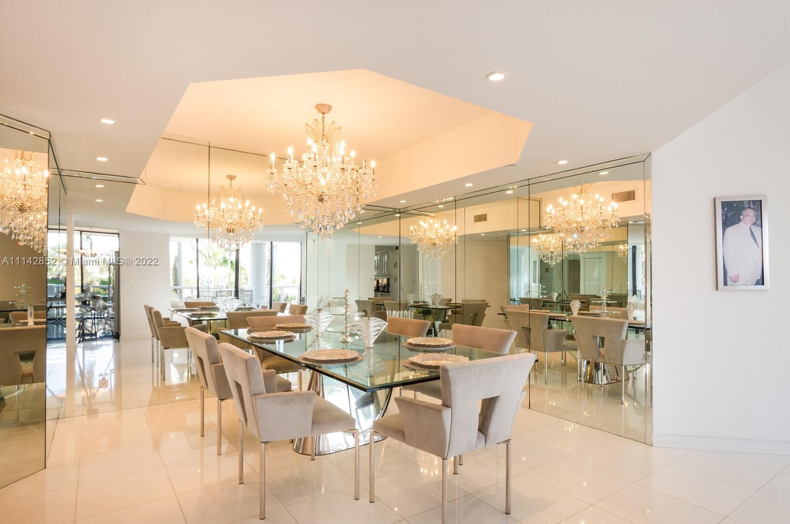 Aventura Aventura, FL 33180 - Photo 21 of 29 a room with lots of tables a chandelier and kitchen view