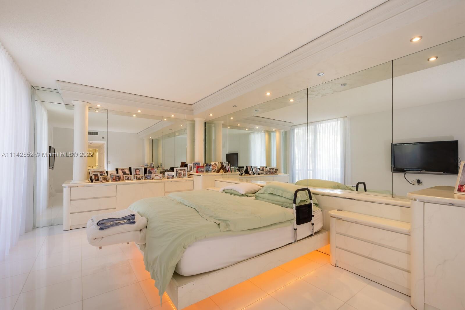 Aventura Aventura, FL 33180 - Photo 23 of 29 a large bedroom with a large bed a flat screen tv and a couch