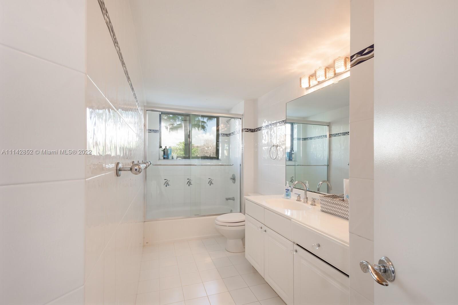 Aventura Aventura, FL 33180 - Photo 27 of 29 a bathroom with a double vanity sink toilet mirror and shower