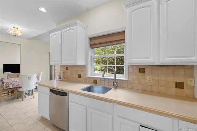 a kitchen with a sink cabinets and window