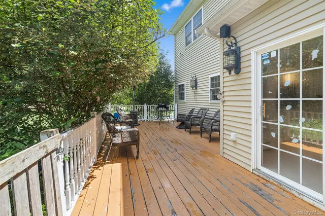a balcony with wooden floor and furniture