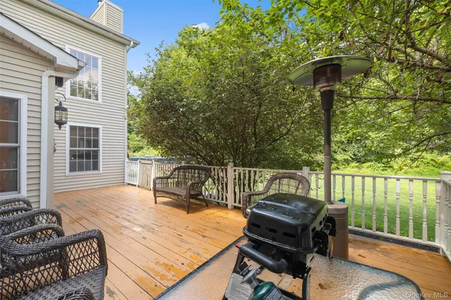 a view of a roof deck with furniture