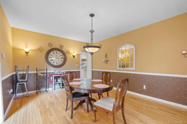 a view of a dining room with furniture and a chandelier