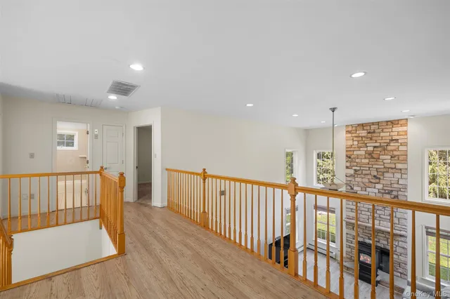 a view of hallway with wooden floor