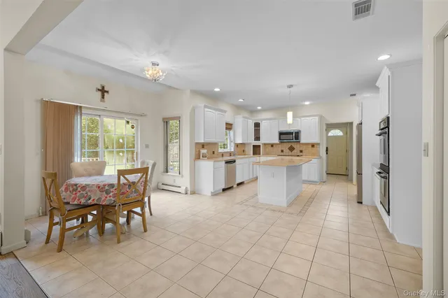 a living room with furniture and kitchen view