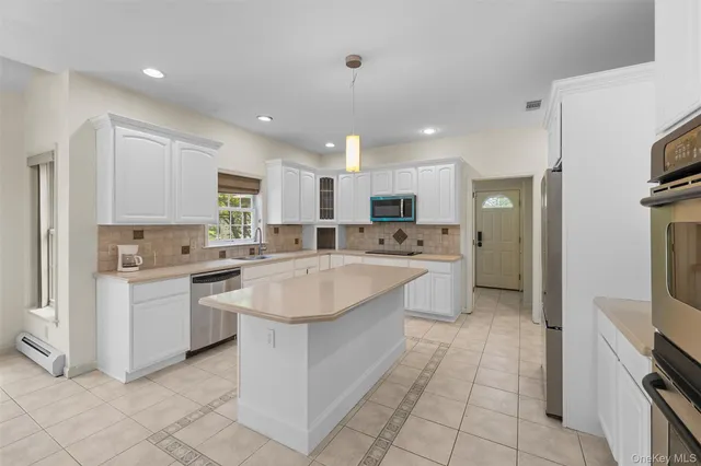a kitchen with a sink counter top space appliances and cabinets