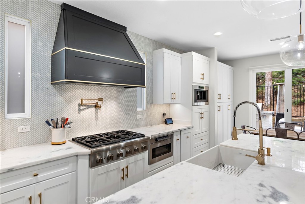 20 Becker Drive Ladera Ranch, CA 92694 - Photo 14 of 47 a kitchen with stainless steel appliances a sink stove and cabinets