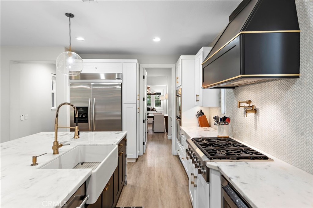 20 Becker Drive Ladera Ranch, CA 92694 - Photo 15 of 47 a kitchen with stainless steel appliances granite countertop a sink stove and refrigerator