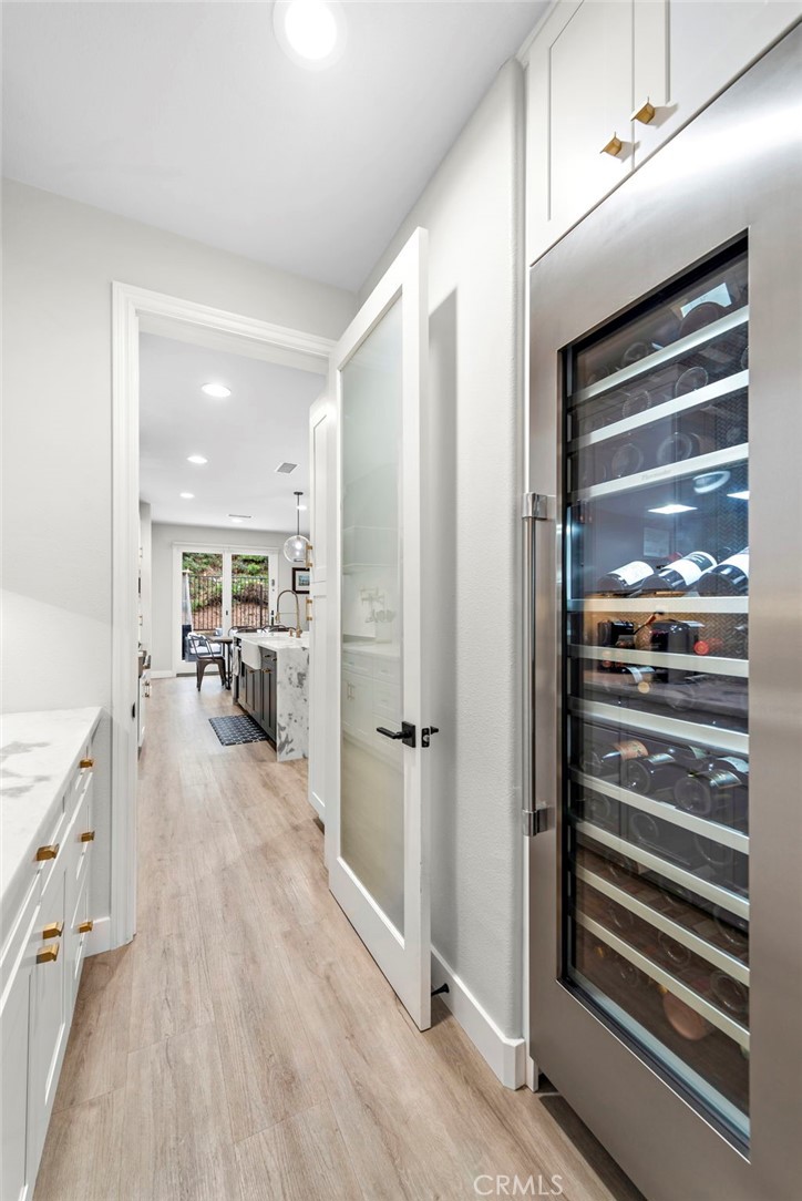 20 Becker Drive Ladera Ranch, CA 92694 - Photo 18 of 47 a view of a hallway with wooden floor cabinets and a kitchen