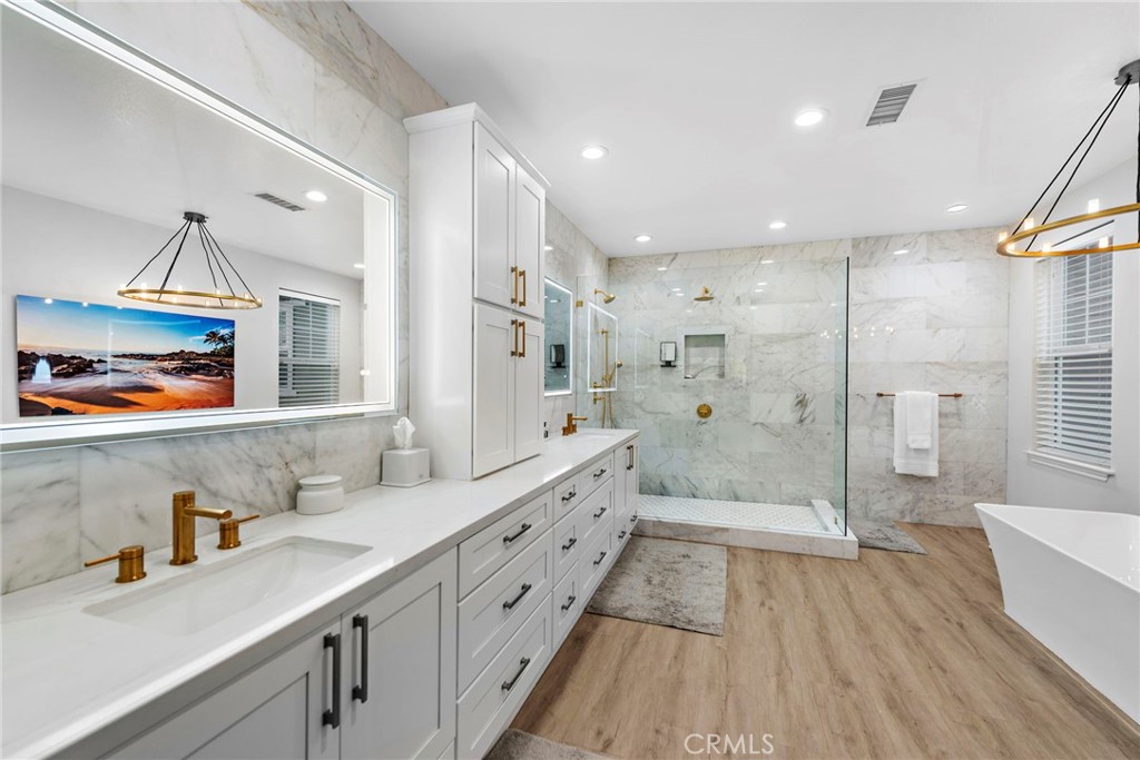 20 Becker Drive Ladera Ranch, CA 92694 - Photo 21 of 47 a bathroom with a double vanity sink a mirror and a shower