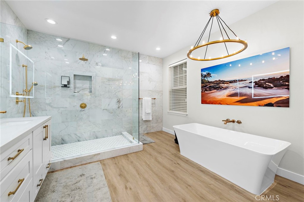 20 Becker Drive Ladera Ranch, CA 92694 - Photo 23 of 47 a bathroom with a sink a mirror a bathtub and shower