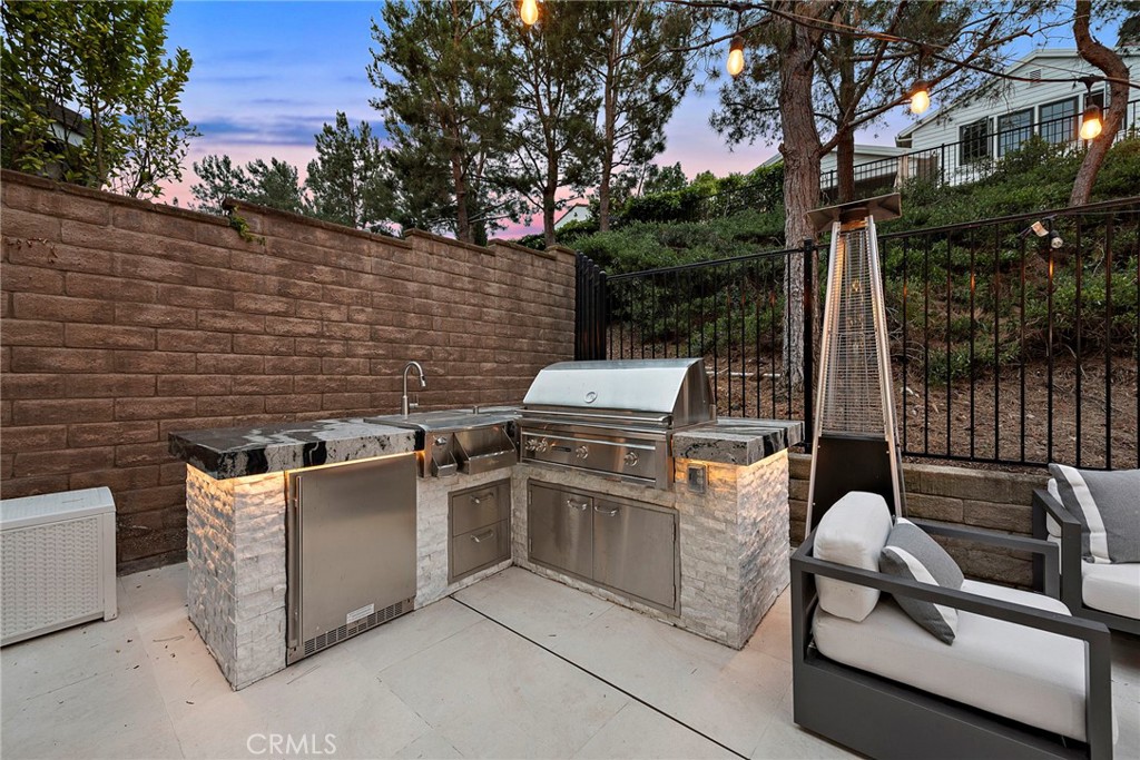20 Becker Drive Ladera Ranch, CA 92694 - Photo 36 of 47 a backyard of a house with barbeque oven and city view