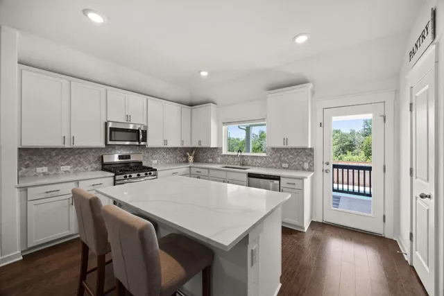 a kitchen with a stove a sink and a refrigerator