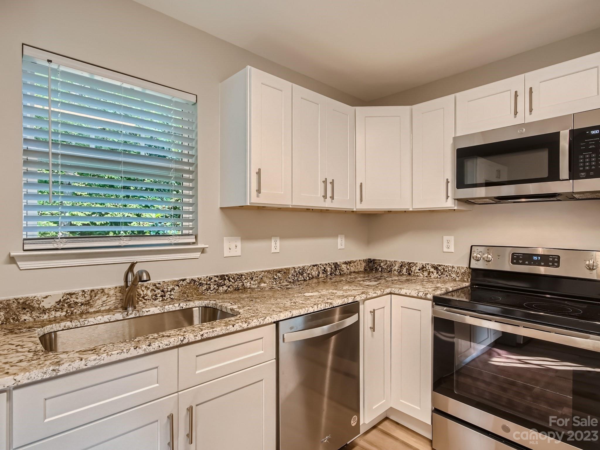 6608 Love Ridge Lane Charlotte, NC 28213 - Photo 11 of 28 a kitchen with granite countertop a sink and steel appliances