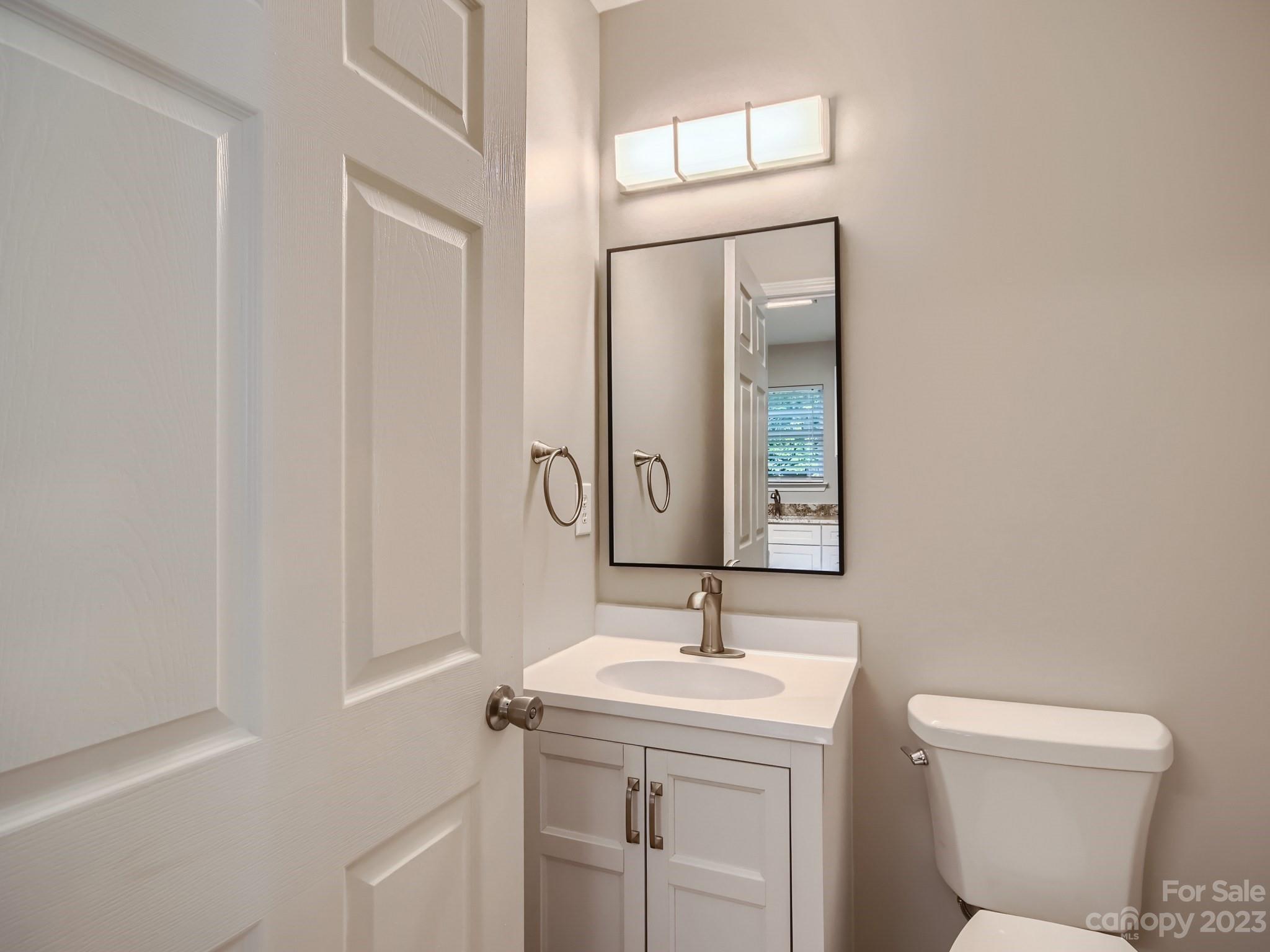 6608 Love Ridge Lane Charlotte, NC 28213 - Photo 13 of 28 a bathroom with a toilet a sink and mirror