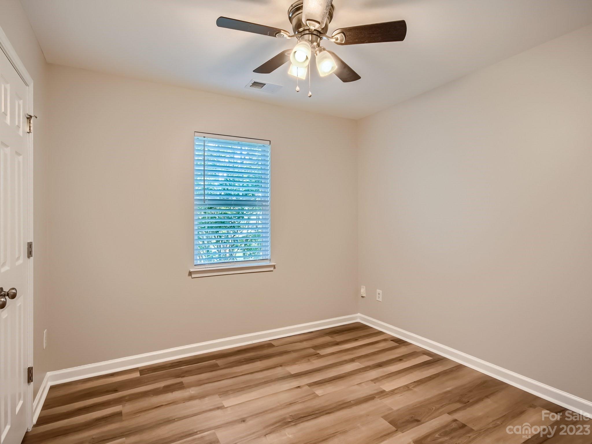6608 Love Ridge Lane Charlotte, NC 28213 - Photo 18 of 28 a view of an empty room with wooden floor and a window