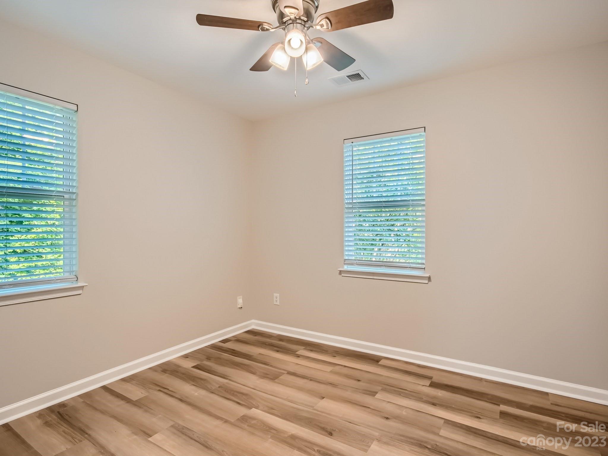 6608 Love Ridge Lane Charlotte, NC 28213 - Photo 20 of 28 a view of an empty room with window and wooden floor