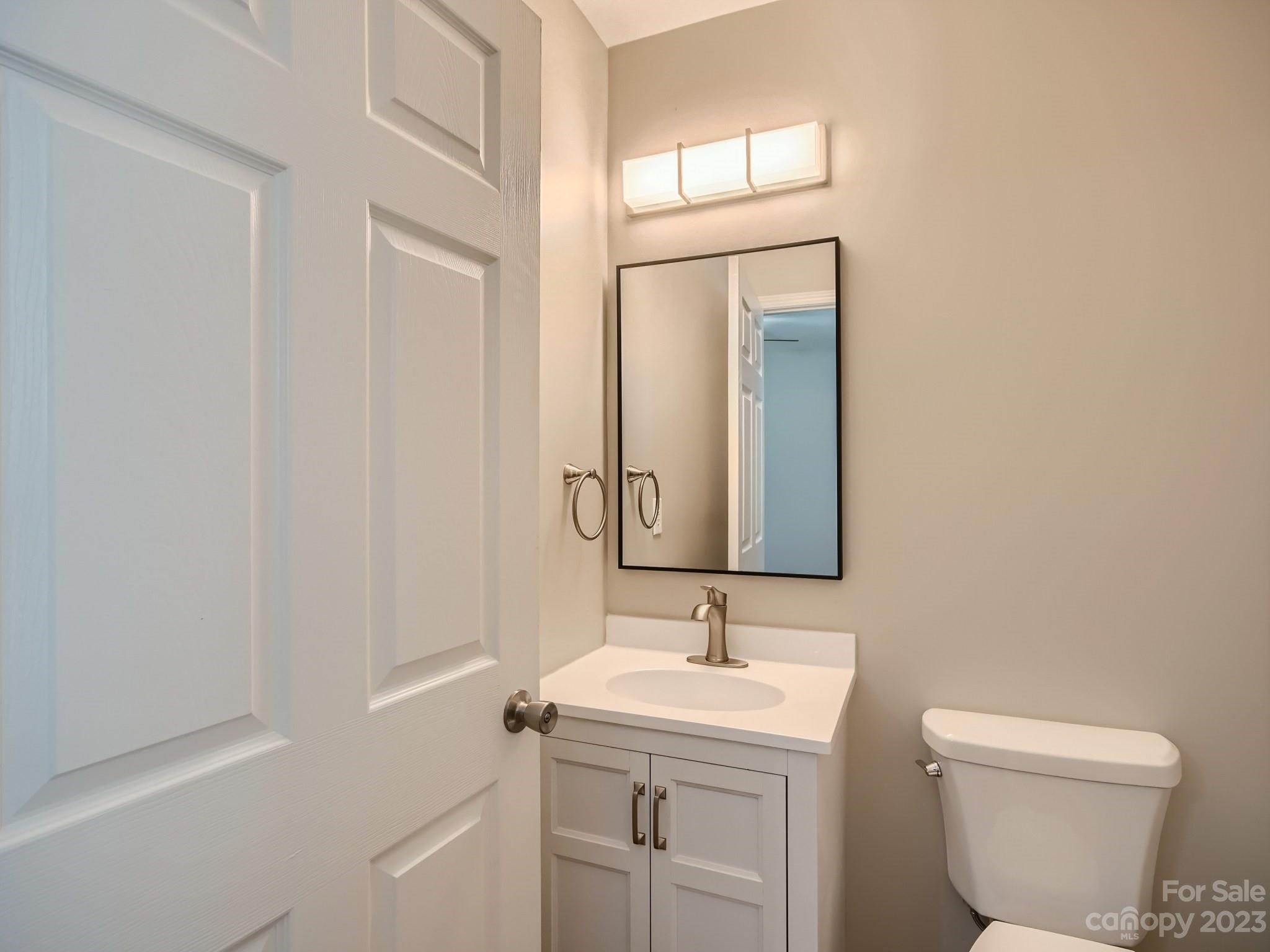 6608 Love Ridge Lane Charlotte, NC 28213 - Photo 21 of 28 a bathroom with a toilet a sink and mirror