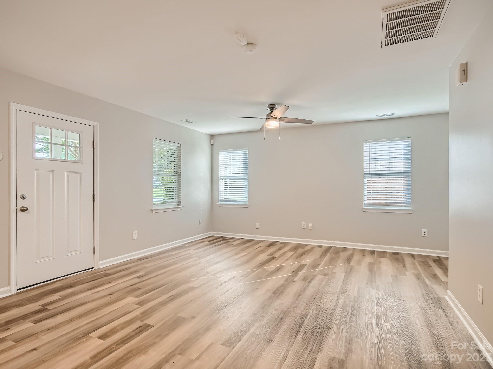 6608 Love Ridge Lane Charlotte, NC 28213 - Photo 6 of 28 a view of an empty room with wooden floor and a window