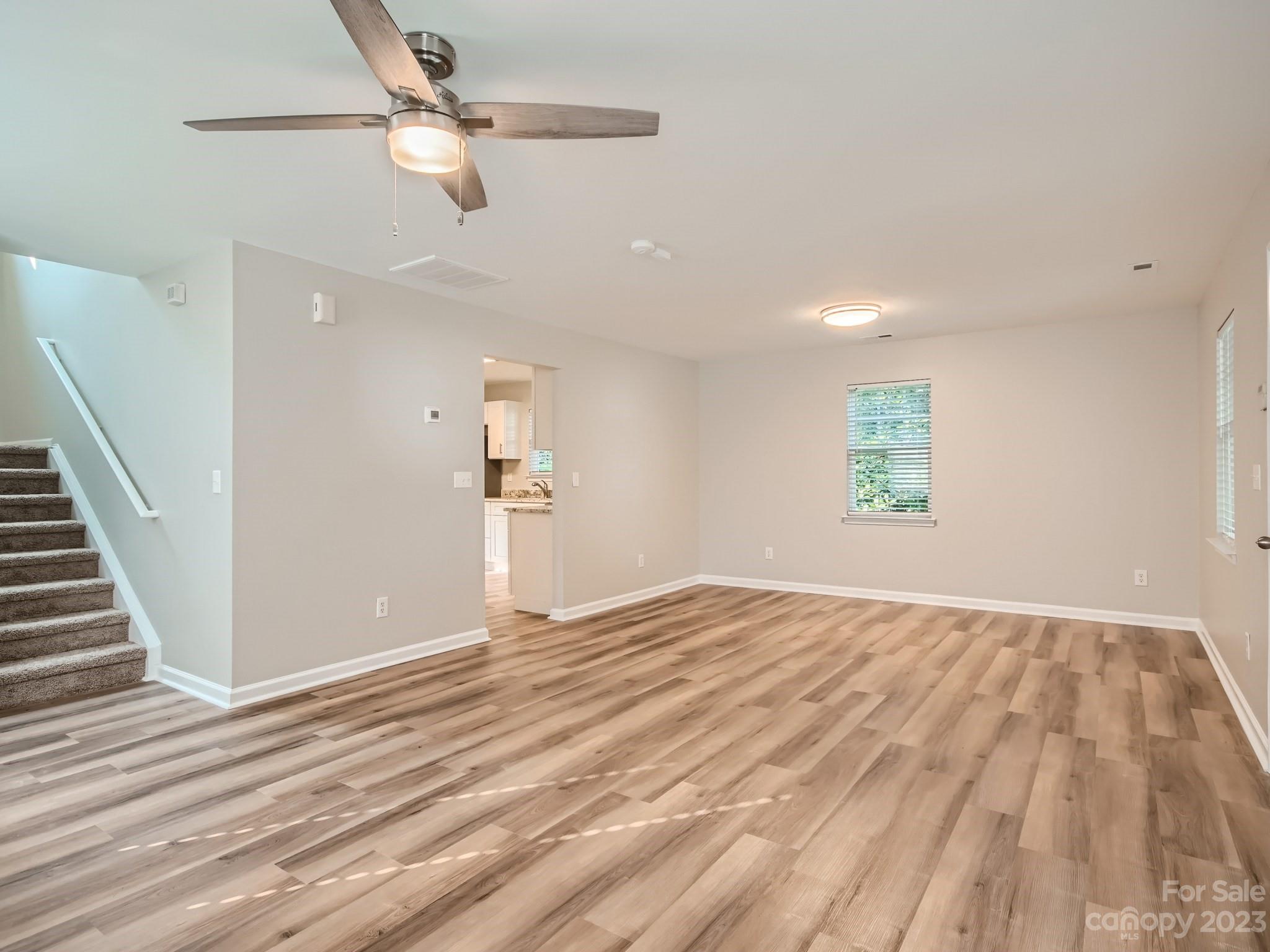 6608 Love Ridge Lane Charlotte, NC 28213 - Photo 8 of 28 a view of empty room with wooden floor and fan