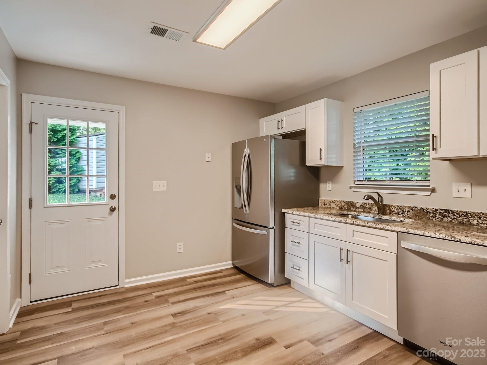 6608 Love Ridge Lane Charlotte, NC 28213 - Photo 9 of 28 a kitchen with a refrigerator stove top oven and sink