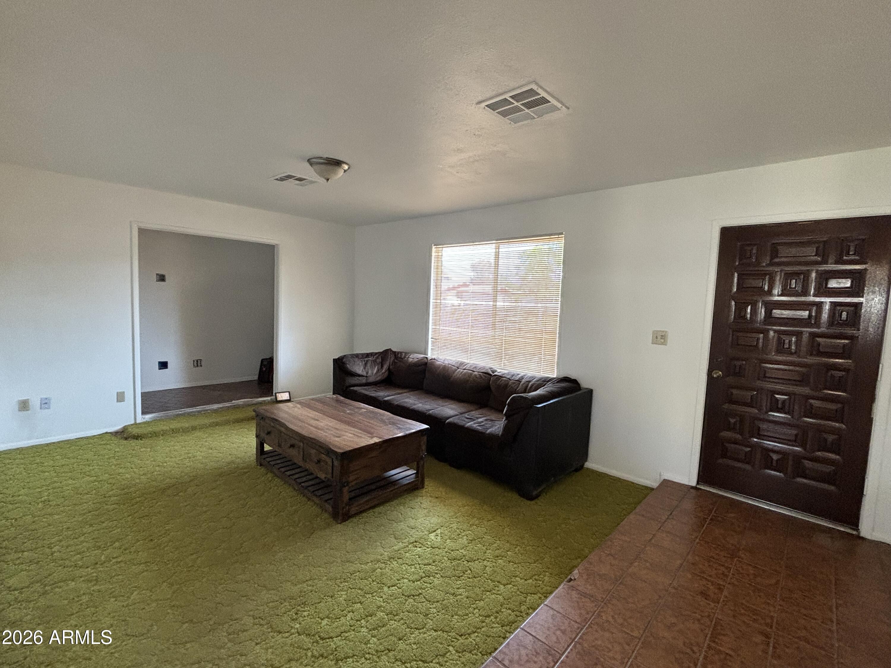 6508 West Fremont Road Laveen, AZ 85339 - Photo 16 of 32 a living room with furniture and a flat screen tv