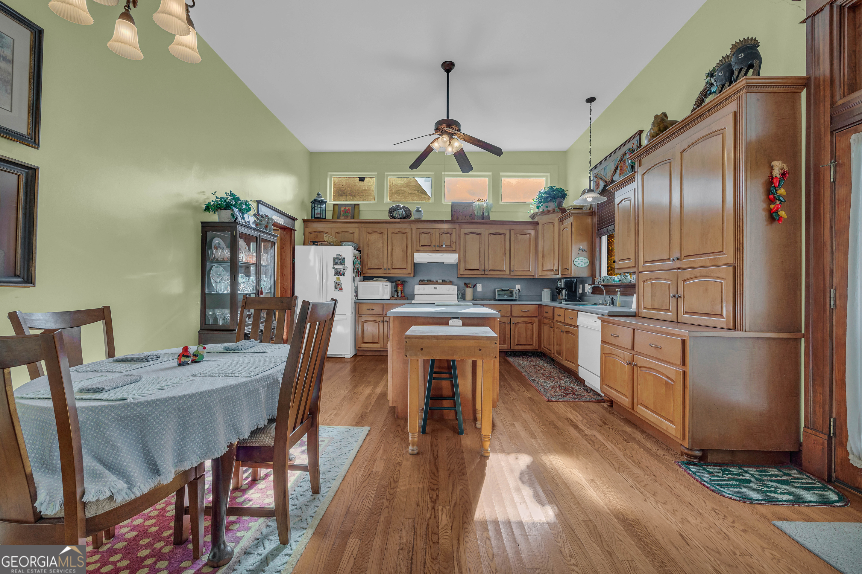 105 South Thomas Street Elberton, GA 30635 - Photo 27 of 57 a kitchen with stainless steel appliances granite countertop a refrigerator a stove top oven a sink dishwasher and white cabinets with wooden floor