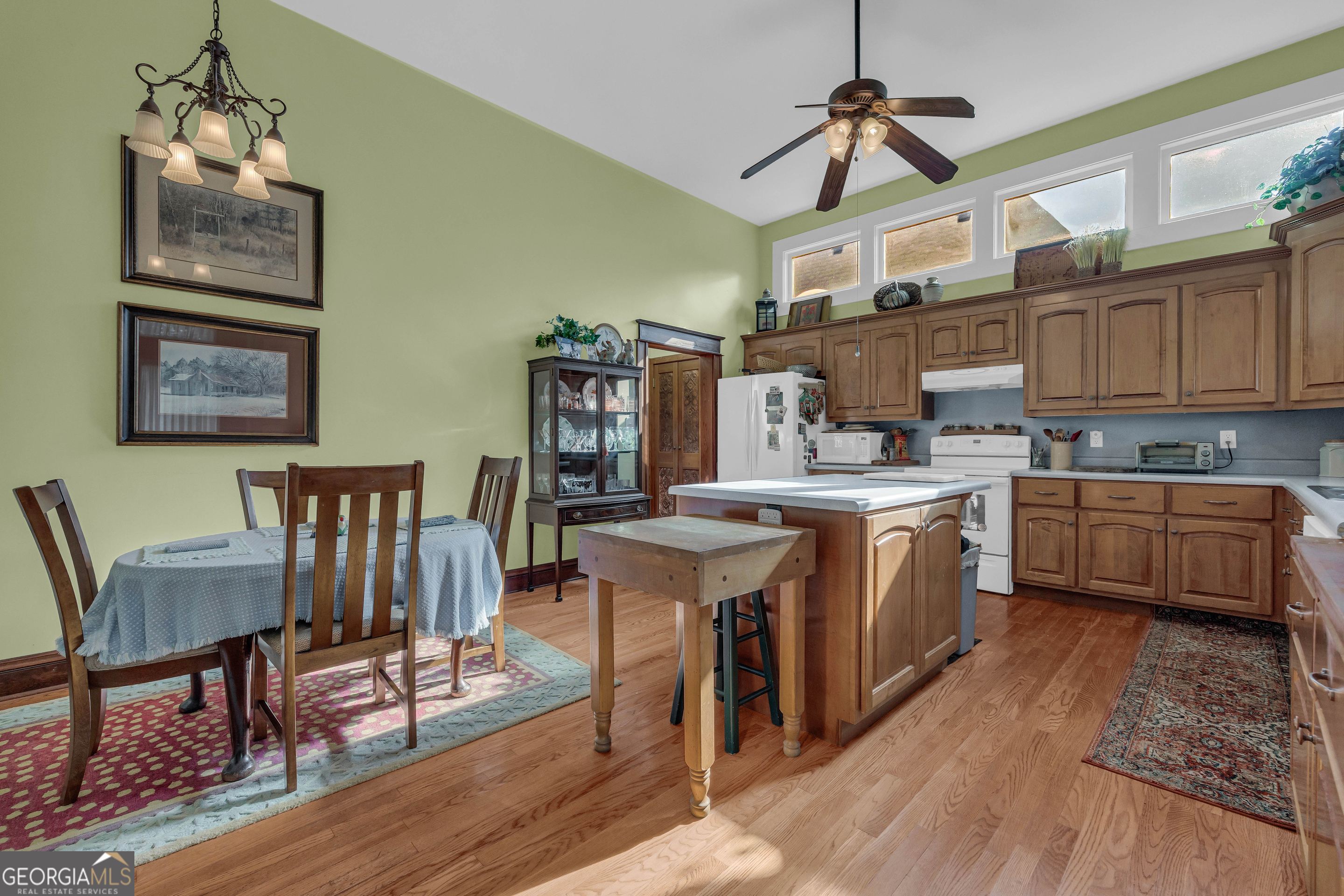 105 South Thomas Street Elberton, GA 30635 - Photo 28 of 57 a kitchen with stainless steel appliances granite countertop a stove top oven a sink dishwasher and white cabinets with wooden floor