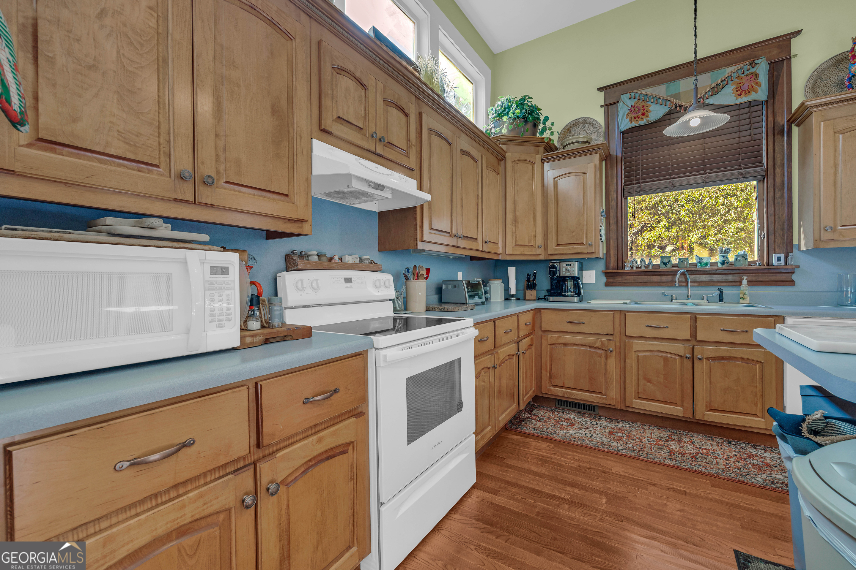 105 South Thomas Street Elberton, GA 30635 - Photo 31 of 57 a kitchen with cabinets appliances a sink and a counter space