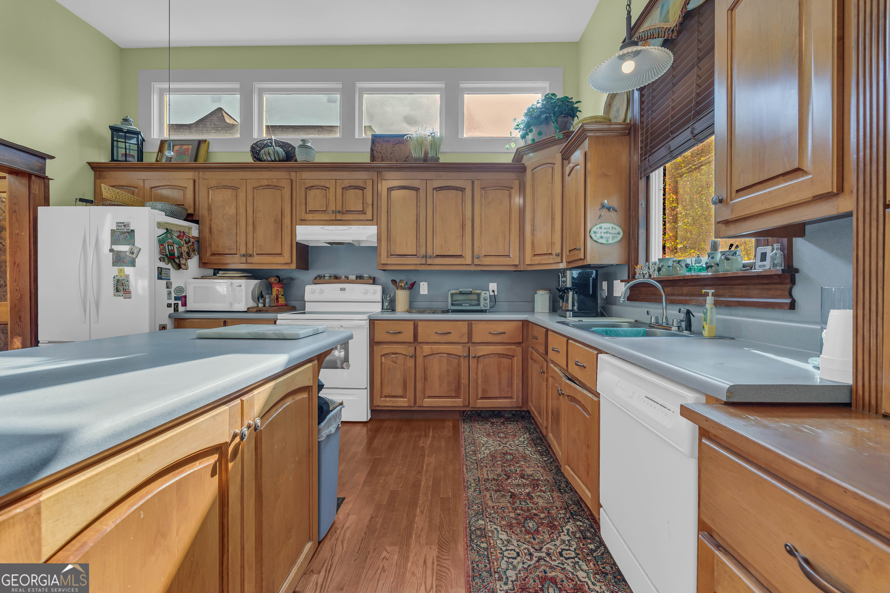 105 South Thomas Street Elberton, GA 30635 - Photo 32 of 57 a kitchen with stainless steel appliances granite countertop a sink and cabinets