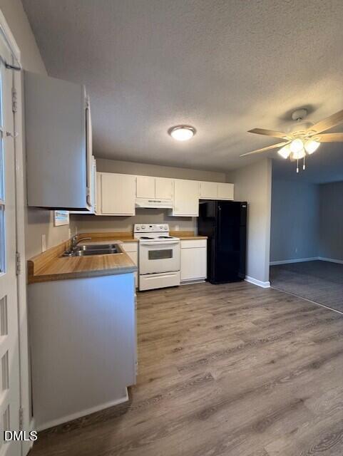 737 North Main Street Wake Forest, NC 27587 - Photo 6 of 11 a large kitchen with stainless steel appliances granite countertop a stove and a refrigerator