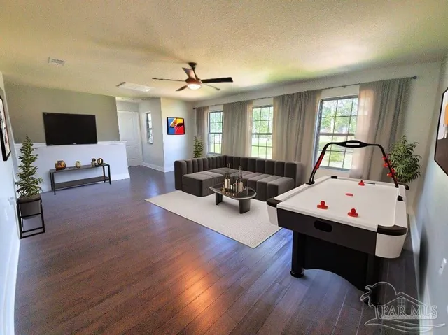 a living room with furniture and a flat screen tv