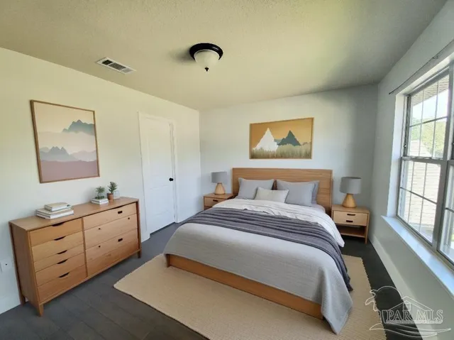 a bedroom with a bed and a window