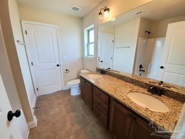 a spacious bathroom with a granite countertop sink and a mirror