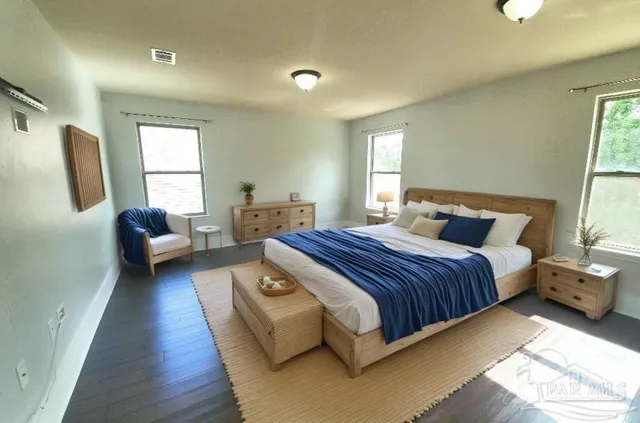 a bedroom with a bed couch and a window