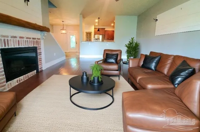 a living room with furniture a fireplace and a flat screen tv