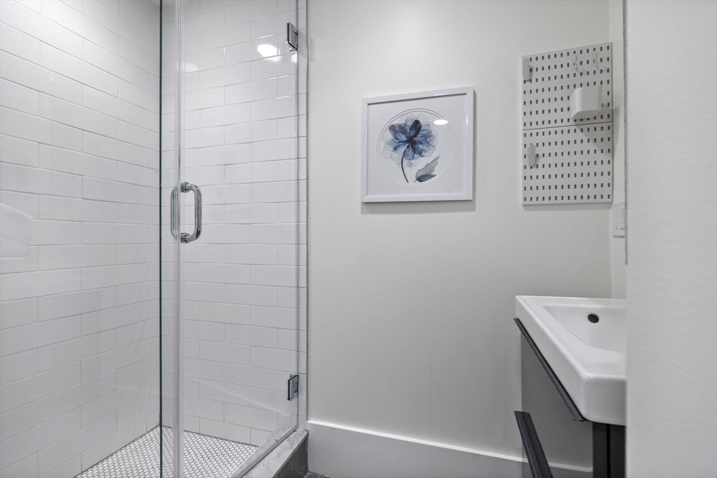 62 Atherton Road, Unit 1 Brookline, MA 02446 - Photo 18 of 24 a bathroom with a bathtub and shower