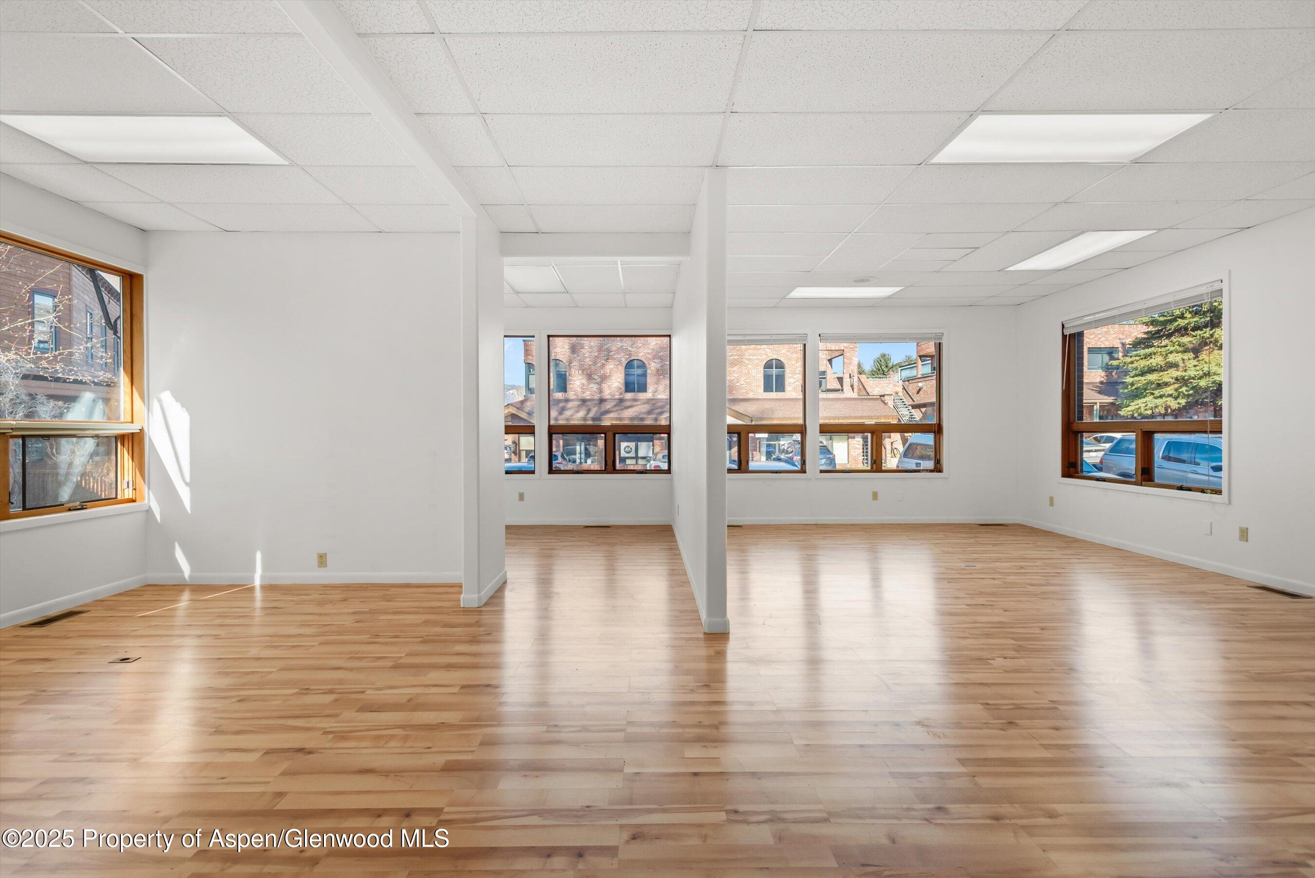 207 Basalt Center Circle, Unit 104 Basalt, CO 81621 - Photo 3 of 13 a view of an empty room with window and wooden floor