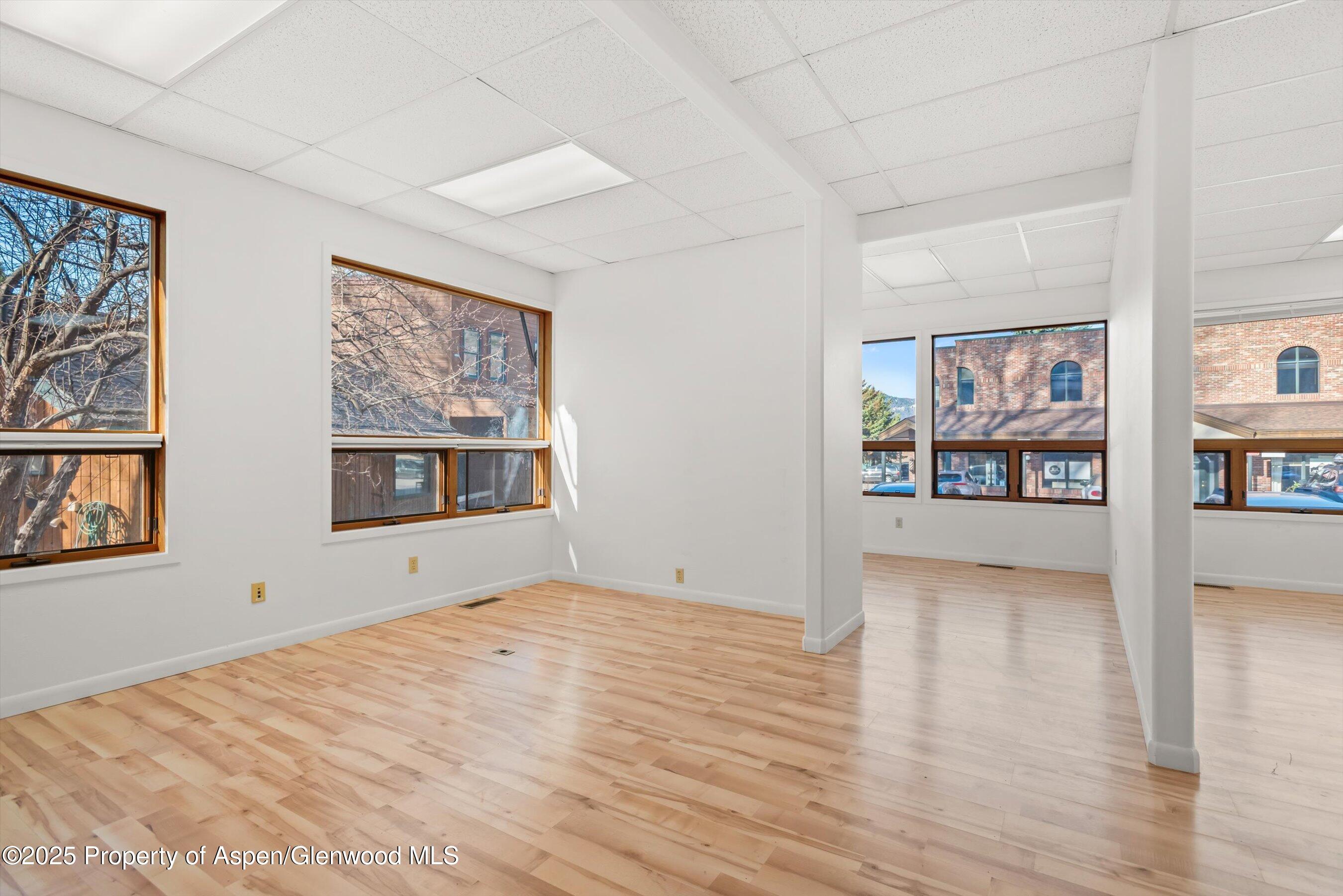 207 Basalt Center Circle, Unit 104 Basalt, CO 81621 - Photo 5 of 13 a view of an empty room with window and wooden floor
