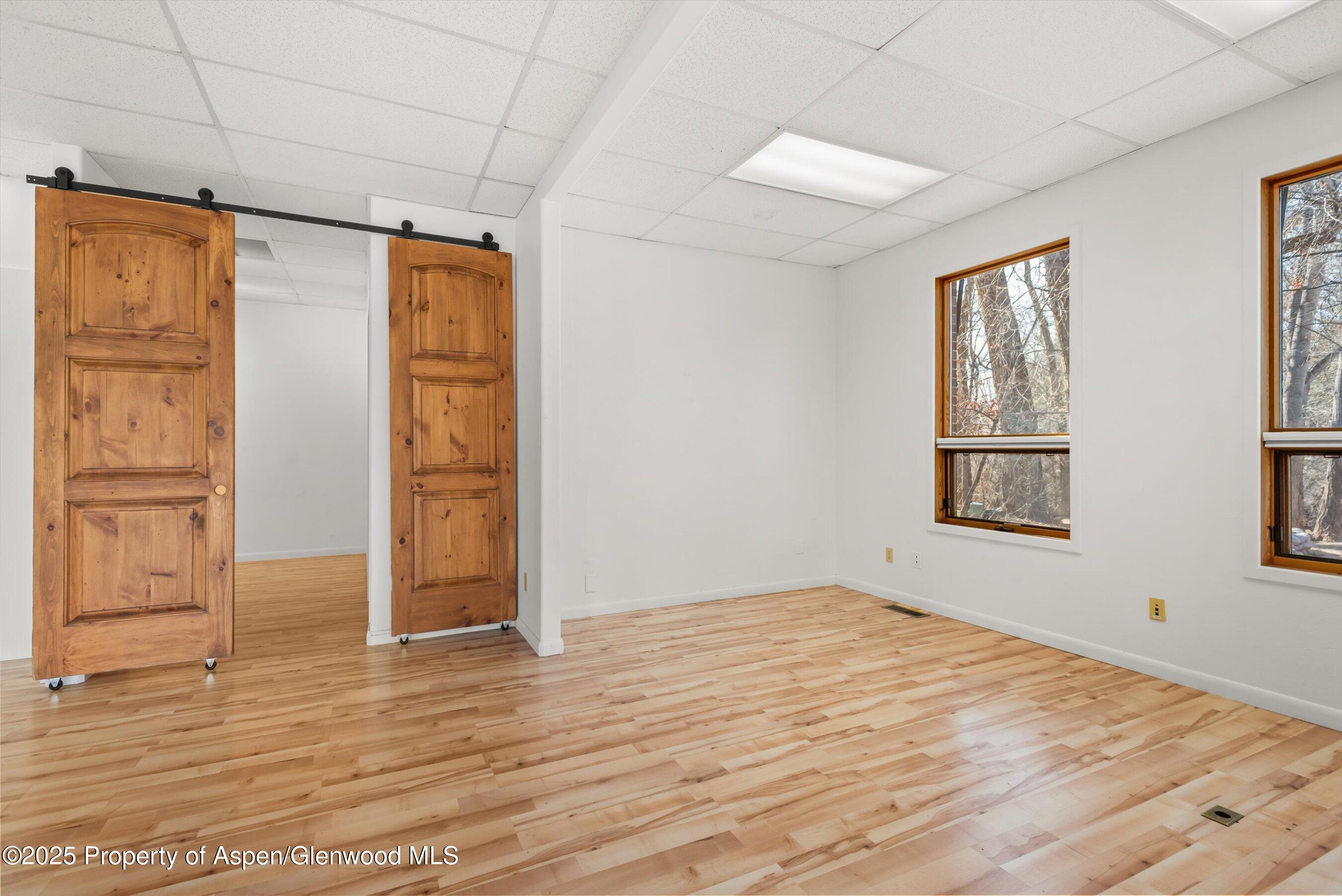 207 Basalt Center Circle, Unit 104 Basalt, CO 81621 - Photo 7 of 13 a view of empty room with wooden floor and fan