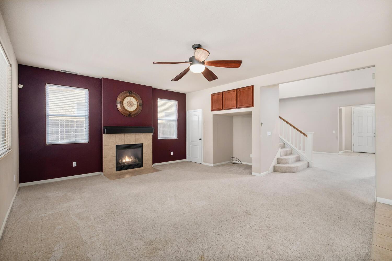 1182 Carson Avenue Clovis, CA 93611 - Photo 11 of 38 a view of an empty room with chandelier fan and windows