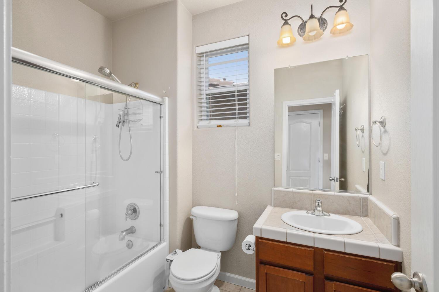 1182 Carson Avenue Clovis, CA 93611 - Photo 19 of 38 a bathroom with a sink a toilet and shower