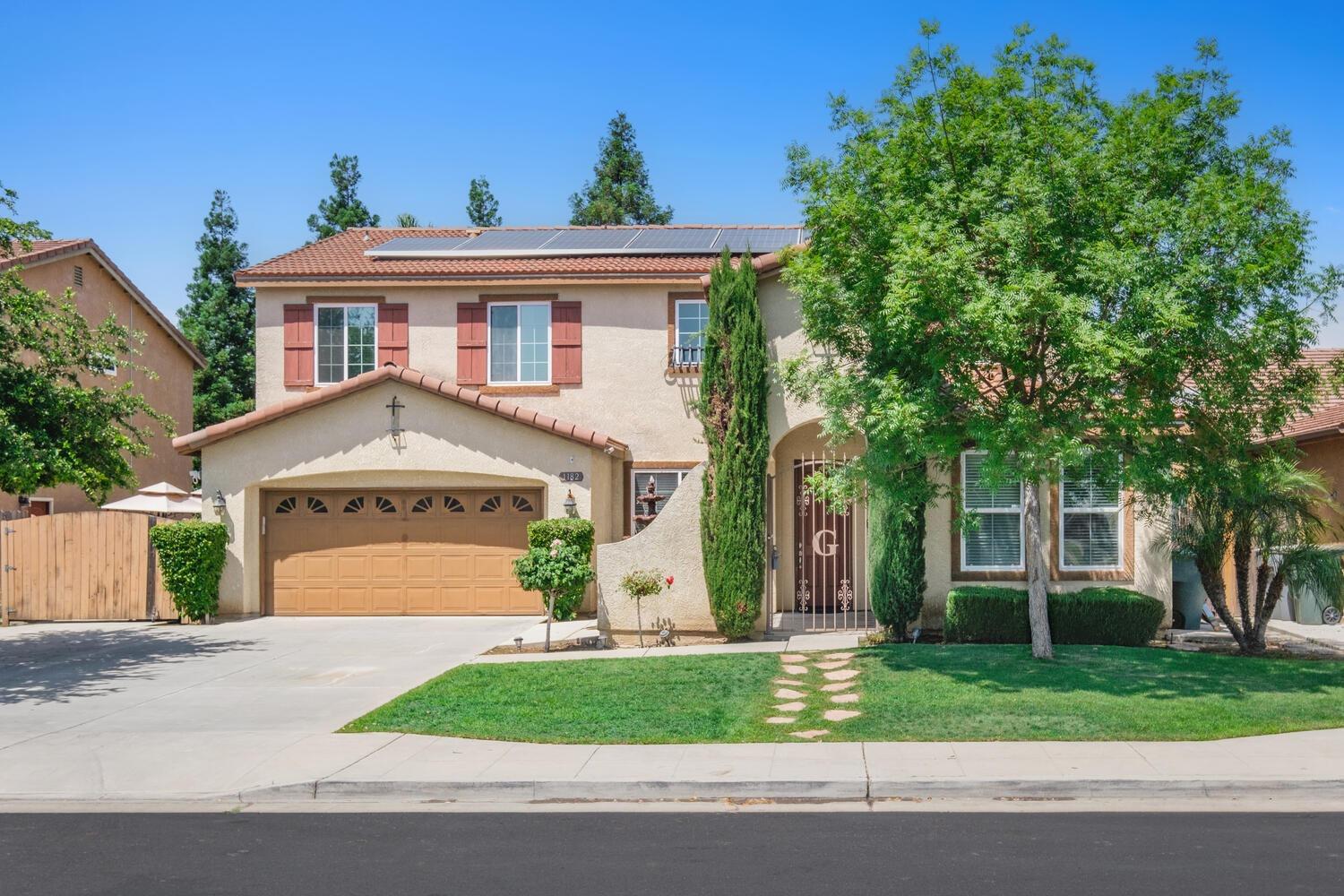 1182 Carson Avenue Clovis, CA 93611 - Photo 2 of 38 front view of a house with a yard