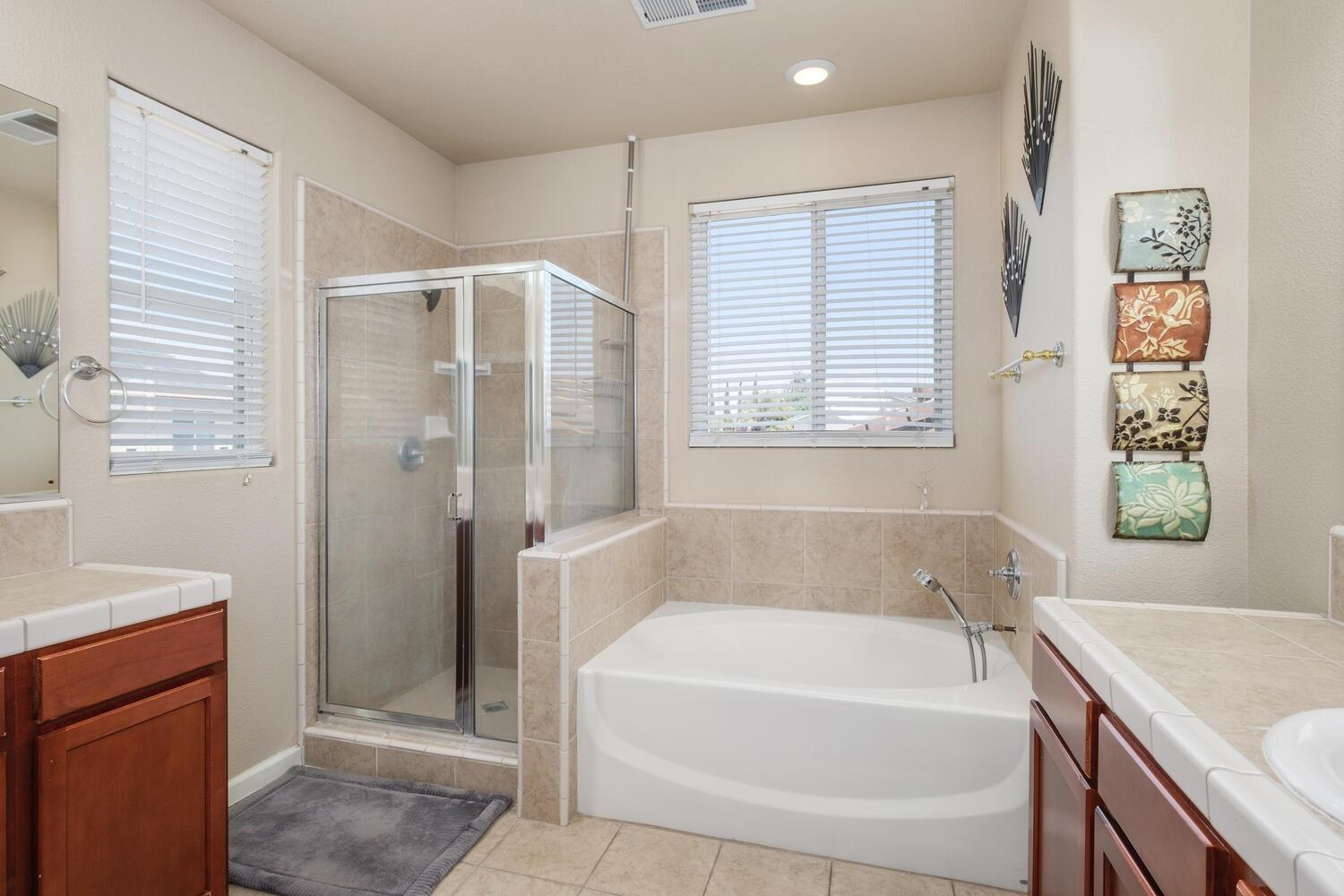 1182 Carson Avenue Clovis, CA 93611 - Photo 24 of 38 a white bath tub sitting next to a white sink