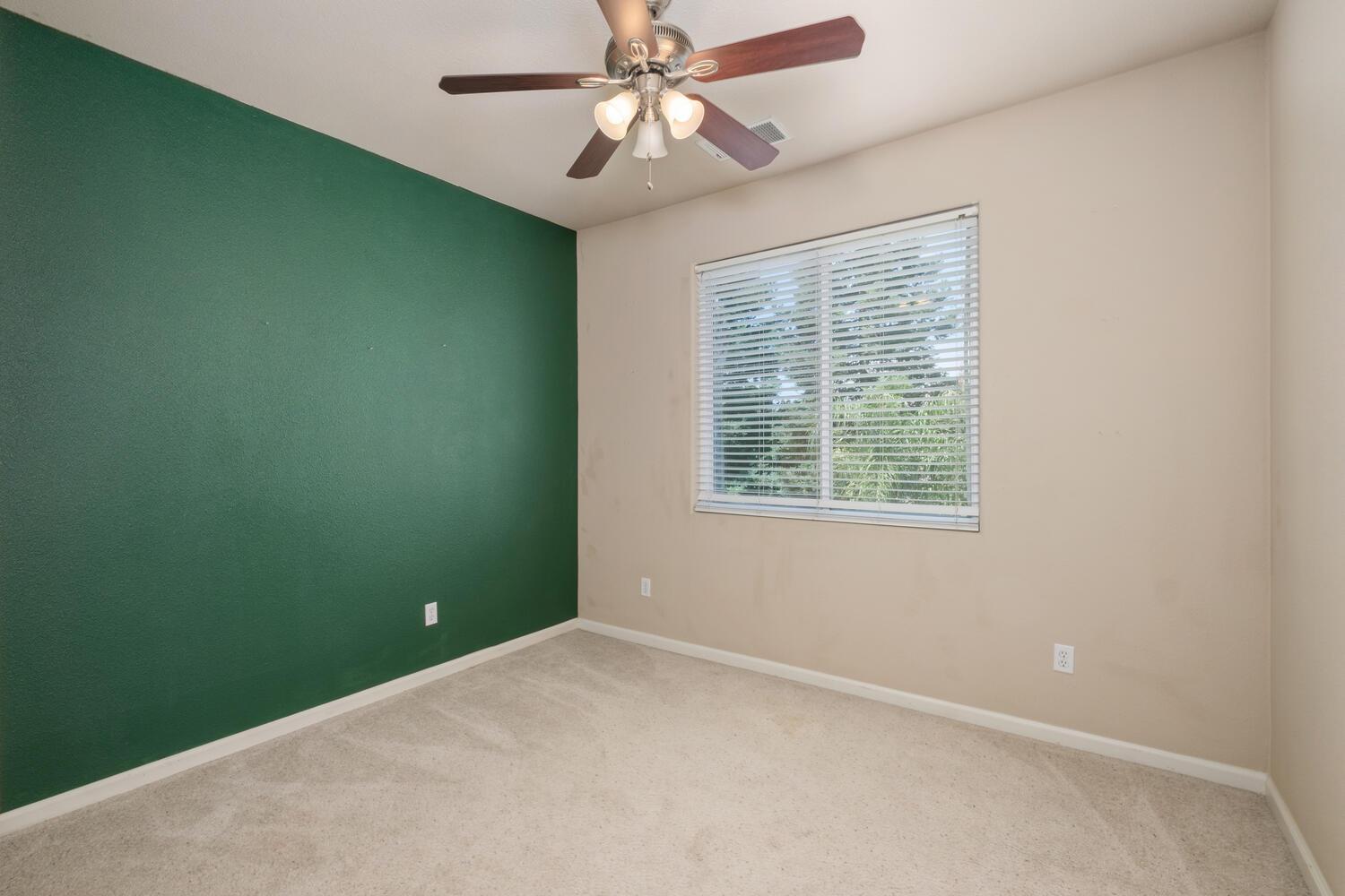 1182 Carson Avenue Clovis, CA 93611 - Photo 27 of 38 an empty room with a window and a fan
