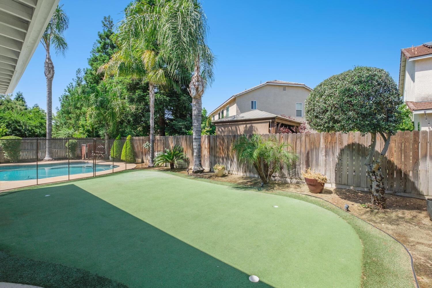 1182 Carson Avenue Clovis, CA 93611 - Photo 32 of 38 a view of a house with a backyard and a small yard