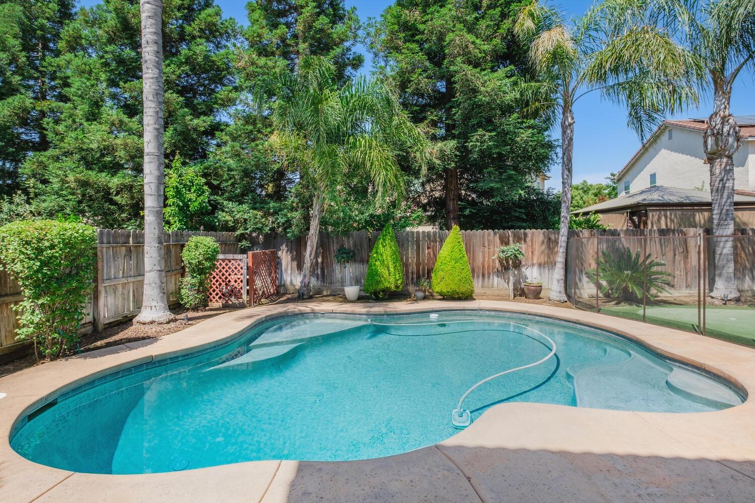 1182 Carson Avenue Clovis, CA 93611 - Photo 33 of 38 a view of a swimming pool with a patio and a yard