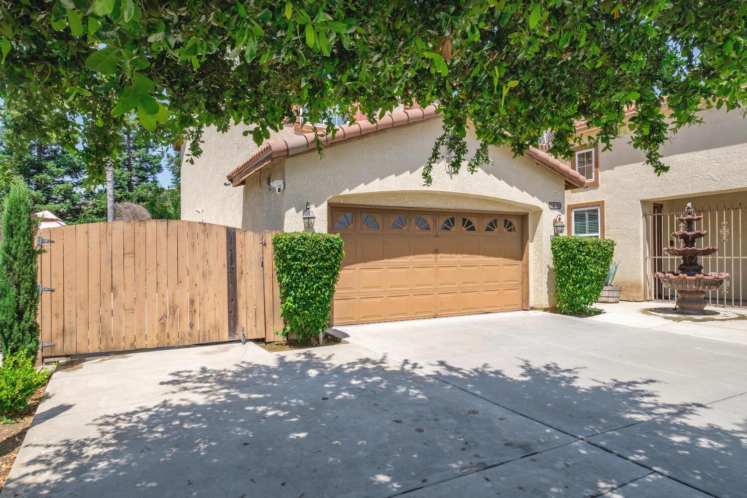 1182 Carson Avenue Clovis, CA 93611 - Photo 36 of 38 a front view of a house with a yard and garage