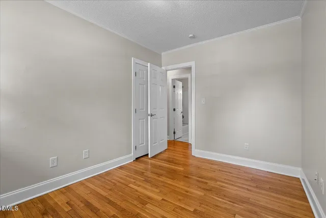 a view of a room with wooden floor