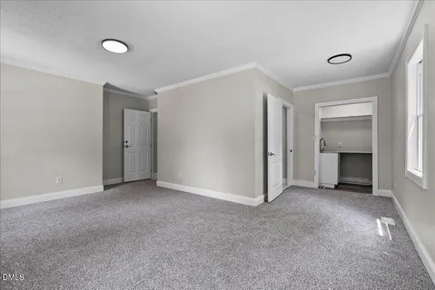 a view of empty room with a fireplace